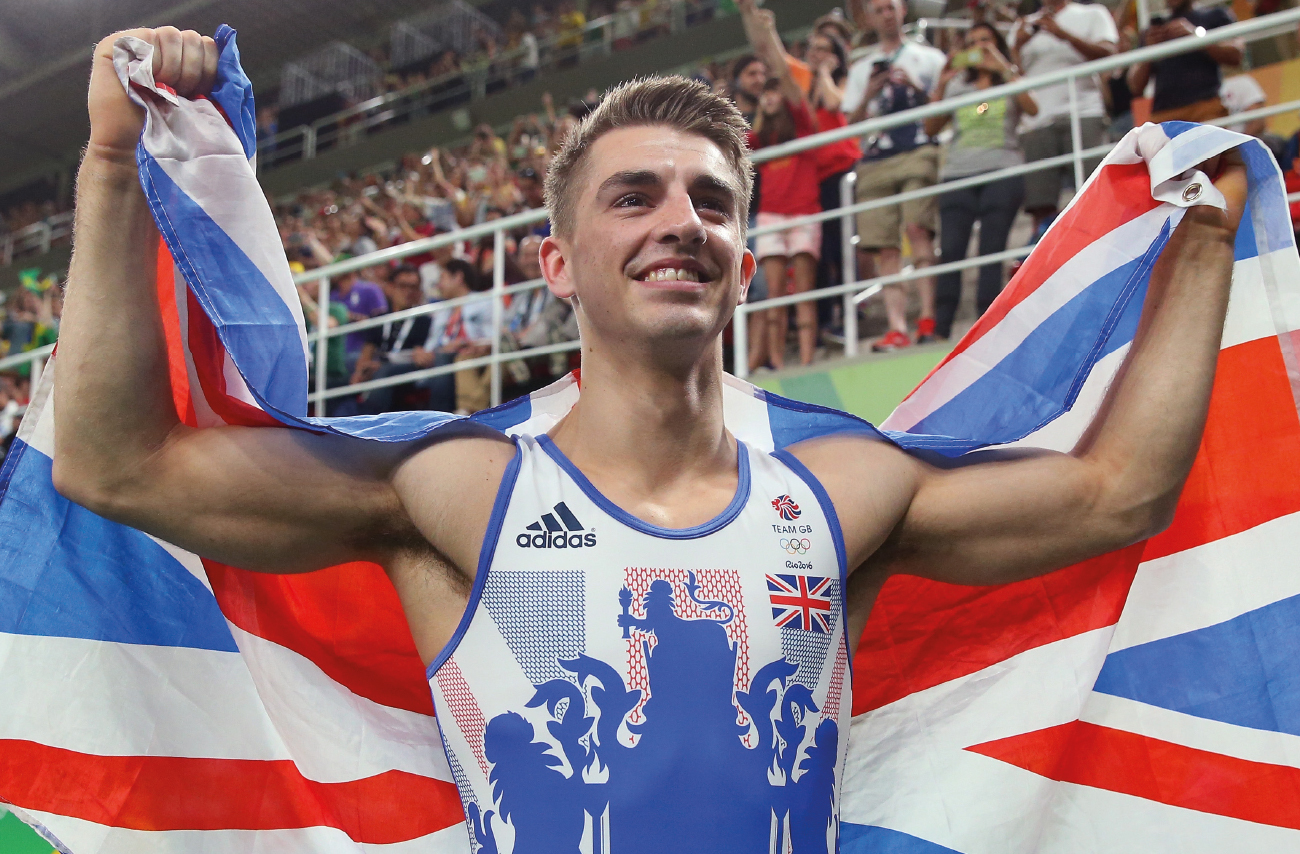 Team GB athlete holding union jack and smiling